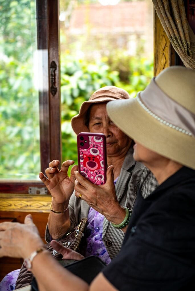 Two women on a train take a picture.