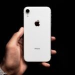 person holding white iphone 4